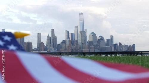 New York City waterfront skyline, Manhattan Downtown World Trade Center skyscraper. Cityscape from New Jersey, United States. American flag 11 September, USA. Independence and Remembrance symbol. Wind