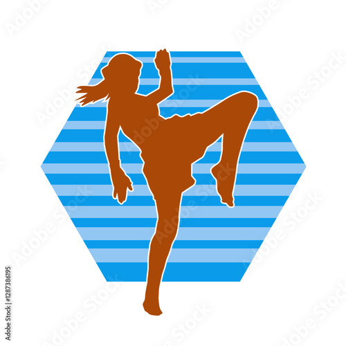 Silhouette of a sporty female in martial art pose. Silhouette of a woman practicing kickboxing.