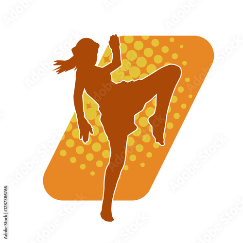 Silhouette of a sporty female in martial art pose. Silhouette of a woman practicing kickboxing.