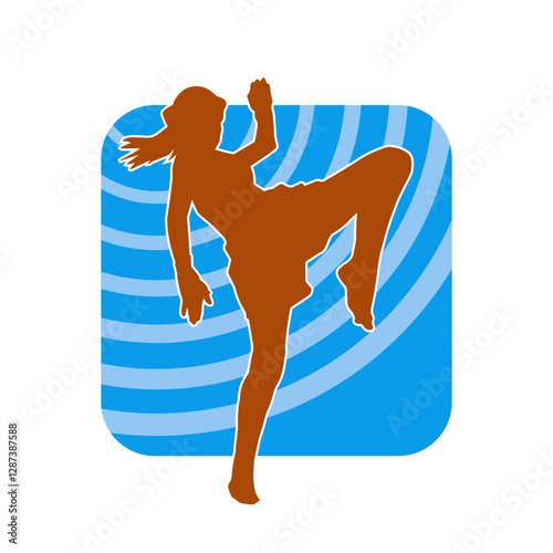 Silhouette of a sporty female in martial art pose. Silhouette of a woman practicing kickboxing.