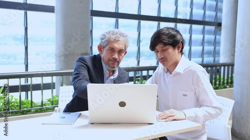 Asian senior professor is giving advice to the college student on the research thesis while sitting in the university faculty for education, academic and business	