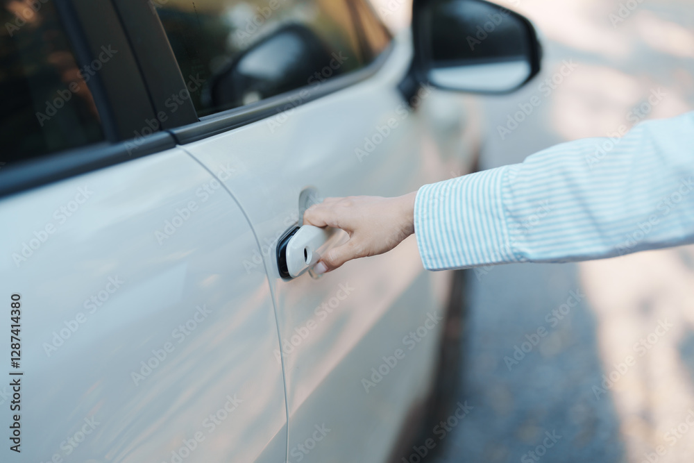 Hand holding smart car handle and opening a door. Transport, travel, service and car rental concept Hand holding smart car handle and opening a door. Transport, travel, service and car rental concept
