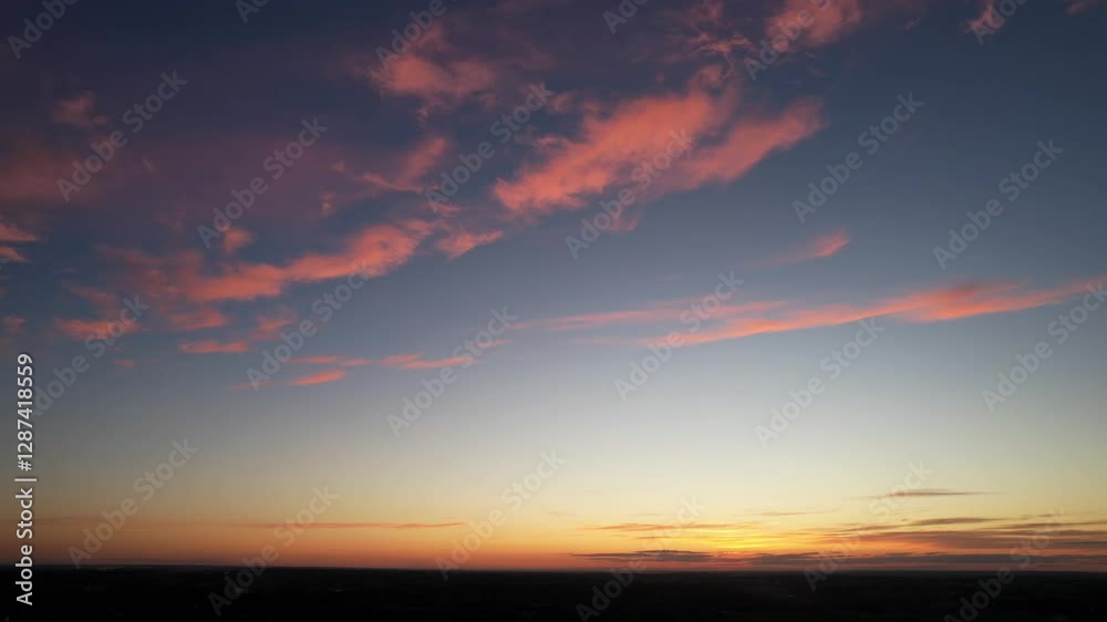 Orange clouds against a dark blue sky Orange clouds against a dark blue sky
