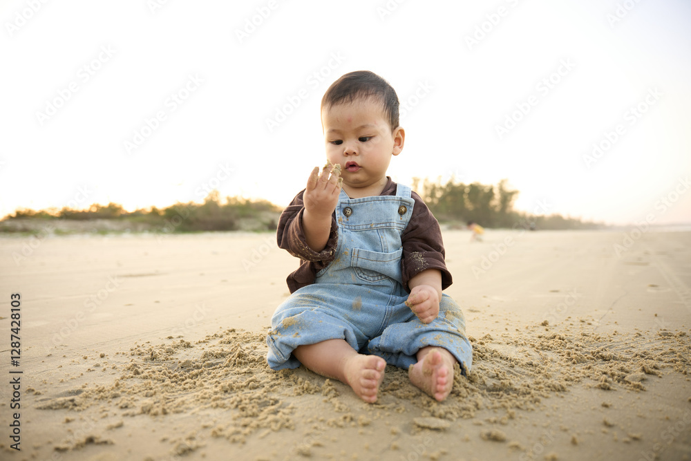 arafed baby sitting on the sand with a hand in his mouth arafed baby sitting on the sand with a hand in his mouth