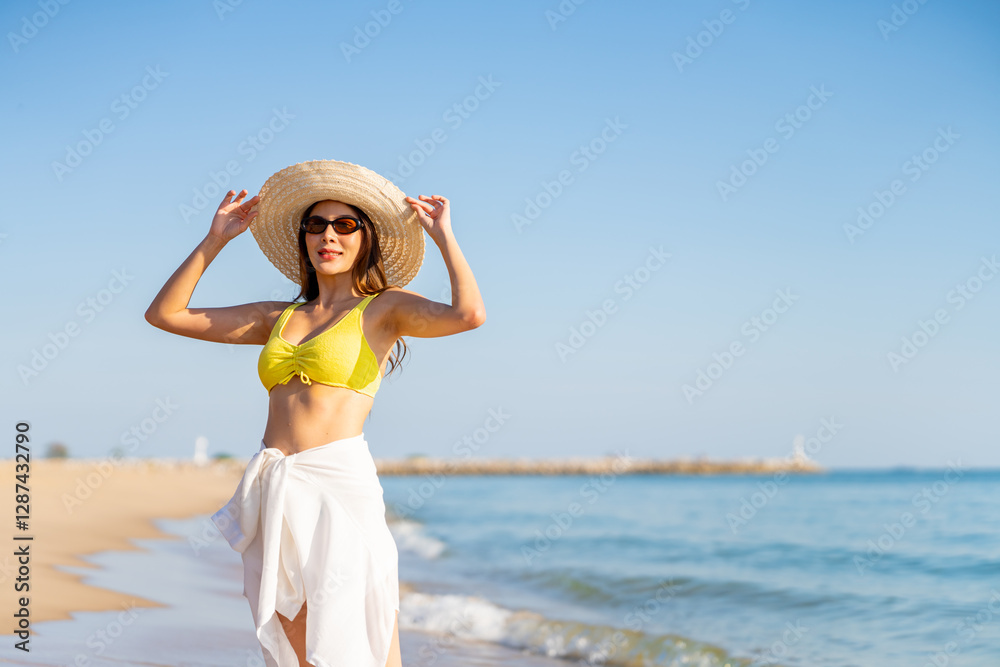 Happy Asian woman travel nature the sea on summer beach holiday vacation. Portrait of Attractive girl in bikini and sun hat enjoy outdoor lifestyle relaxing and walking on tropical beach in sunny day. Happy Asian woman travel nature the sea on summer beach holiday vacation. Portrait of Attractive girl in bikini and sun hat enjoy outdoor lifestyle relaxing and walking on tropical beach in sunny day.