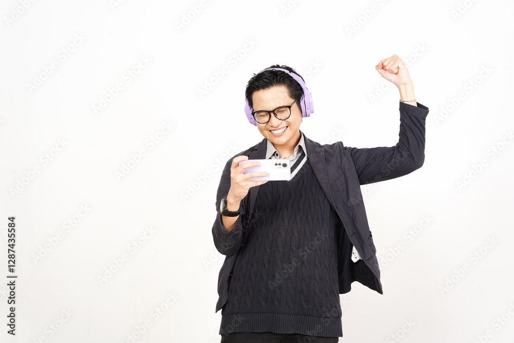 Happy Yes Playing mobile games on smartphone with headphones Of Handsome Asian Man Isolated On White Background Happy Yes Playing mobile games on smartphone with headphones Of Handsome Asian Man Isolated On White Background