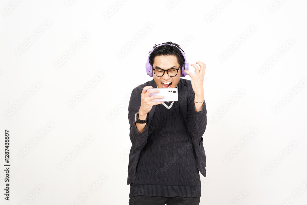 Angry lost Playing mobile games on smartphone with headphones Of Handsome Asian Man Isolated On White Background Angry lost Playing mobile games on smartphone with headphones Of Handsome Asian Man Isolated On White Background