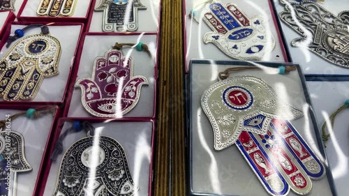 Nazar in market. Blue and red Fatima eye close-up protective amulet against evil eye. Israeli Hamsa David