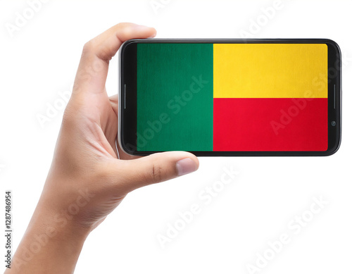 ベナンの国旗が画面に表示されているスマートフォンを持つ手。白背景。(Hand holding smartphone, screen is Benin flag. on white background.)
 photo