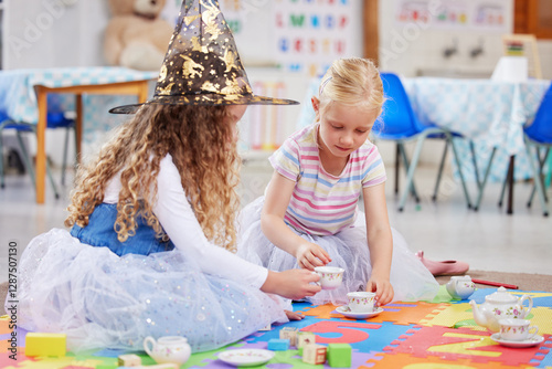 Canvas Print Girl, friends and tea party with play in classroom for witch costume, hat or learning on floor