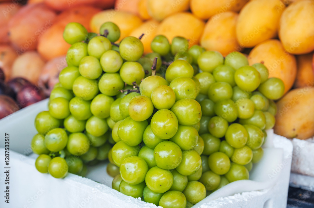 bunch of green Korean grape Shine Muscat on the counter at the market in Asia bunch of green Korean grape Shine Muscat on the counter at the market in Asia