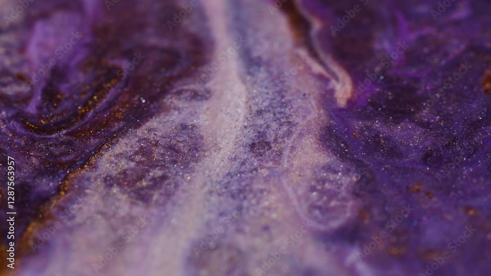 Paint ink. Shiny flow. Defocused multicolor purple shimmering sparkling fluid marble texture bright particles moving on abstract blurred bokeh light art background.