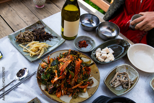 outdoor food table with raw gizzard shad salad seasoned with spicy sauce and vegetables photo