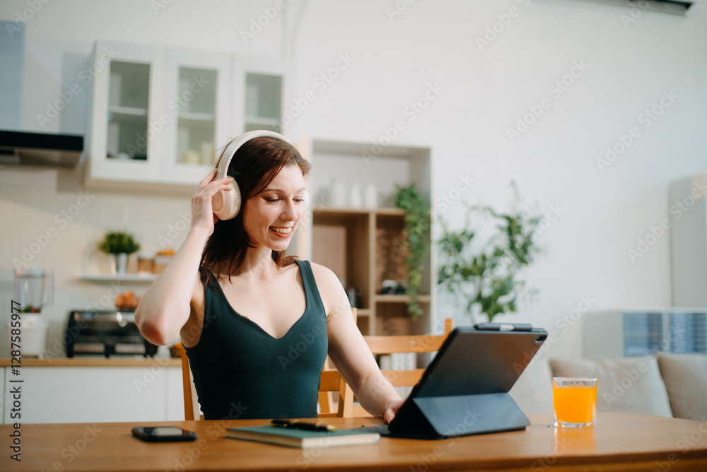 woman with headphones using a laptop in a cozy living room. Perfect for remote work, freelancing, woman with headphones using a laptop in a cozy living room. Perfect for remote work, freelancing,