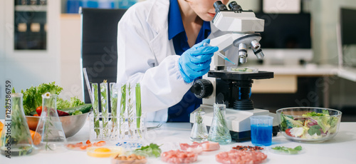 Scientist testing food samples in lab with microscope, vegetables, and meat for safety, nutrition, and biotechnology