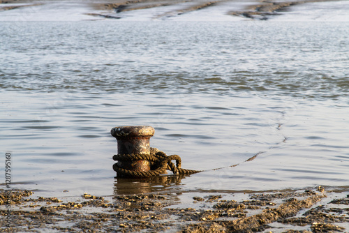 bollard with rope at the seaside photo