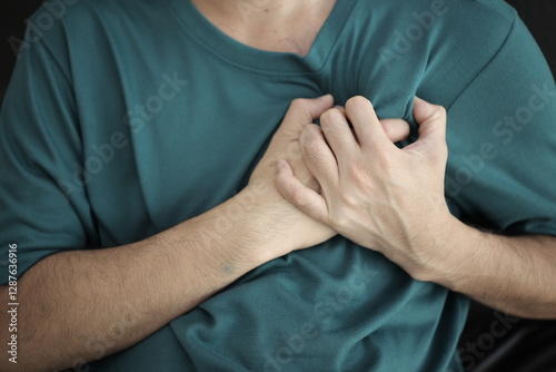 Hands massaging the chest, chest pain, heart pain, heart disease