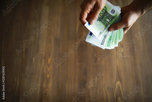 European Union banknotes in hands. A pack of 100 euro banknotes in the hands. Recalculation of cash. photo