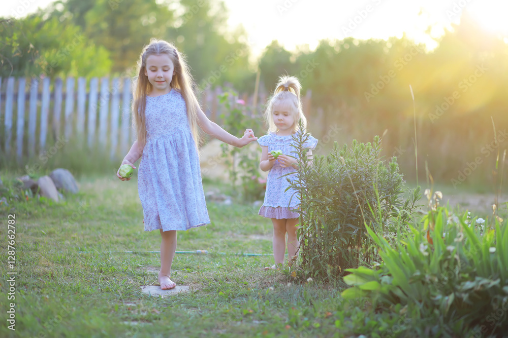 Fototapeta premium Children walk in the summer in nature. Child on a sunny spring morning in the park. Traveling with children.