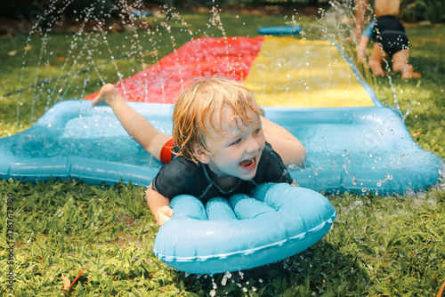 Summer backyard slip and slide family fun