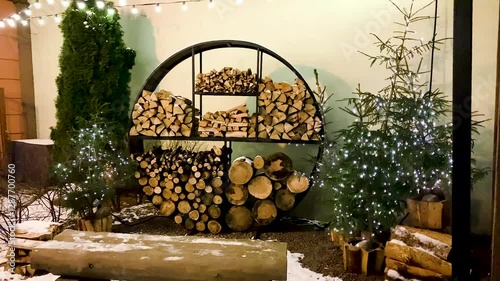 Stacked logs outdoor storage in winter in the backyard Country rural life snowy weather 