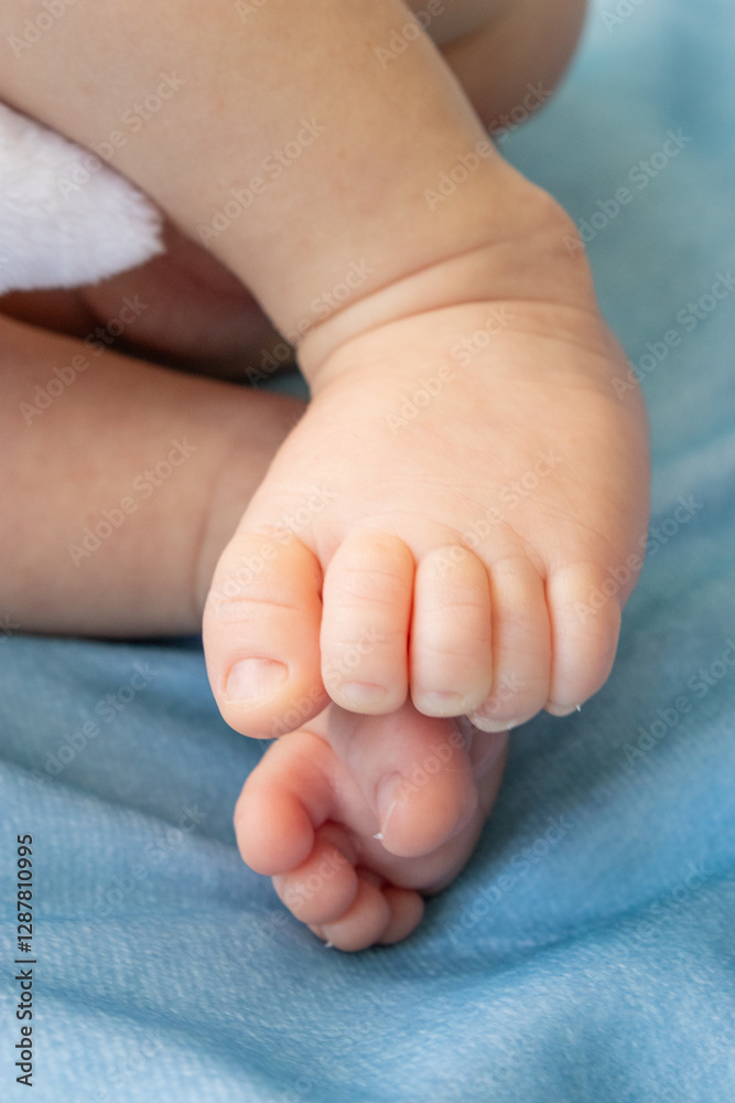 Close up of a newborn baby's tiny feet, sleeping in a cozy bed Close up of a newborn baby's tiny feet, sleeping in a cozy bed