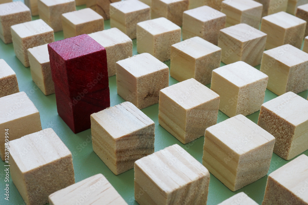 Fototapeta premium One unique cube stands out among aligned blocks. Individuality and creative thinking.