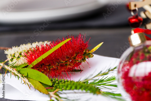 Australian christmas theme table with red native bottlebrush flower, focus on the flower photo