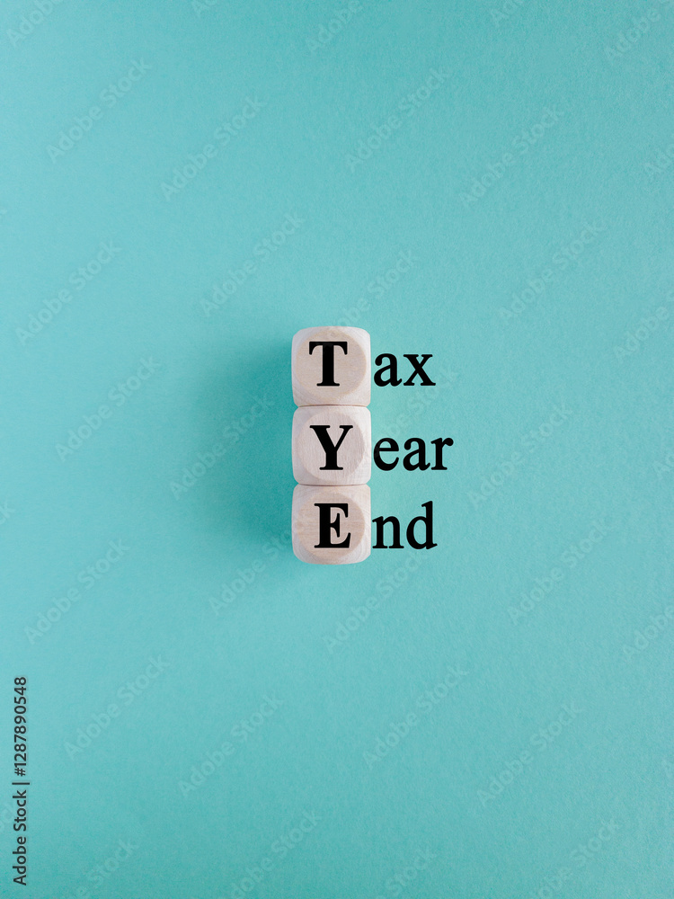 Tax year end symbol. Concept words Tax year end on wooden cubes. Beautiful blue background. Business tax year end concept.
