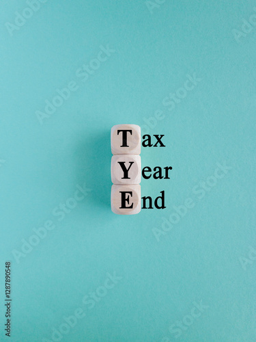 Obraz na płótnie Tax year end symbol. Concept words Tax year end on wooden cubes. Beautiful blue background. Business tax year end concept. w salonie