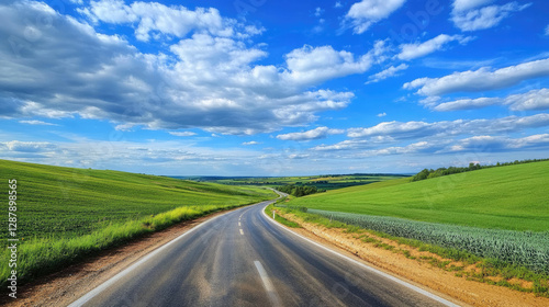 Wallpaper Mural Wide road into distance, flanked by green fields and blue sky. High-definition, horizontal composition. Serene beauty. Torontodigital.ca