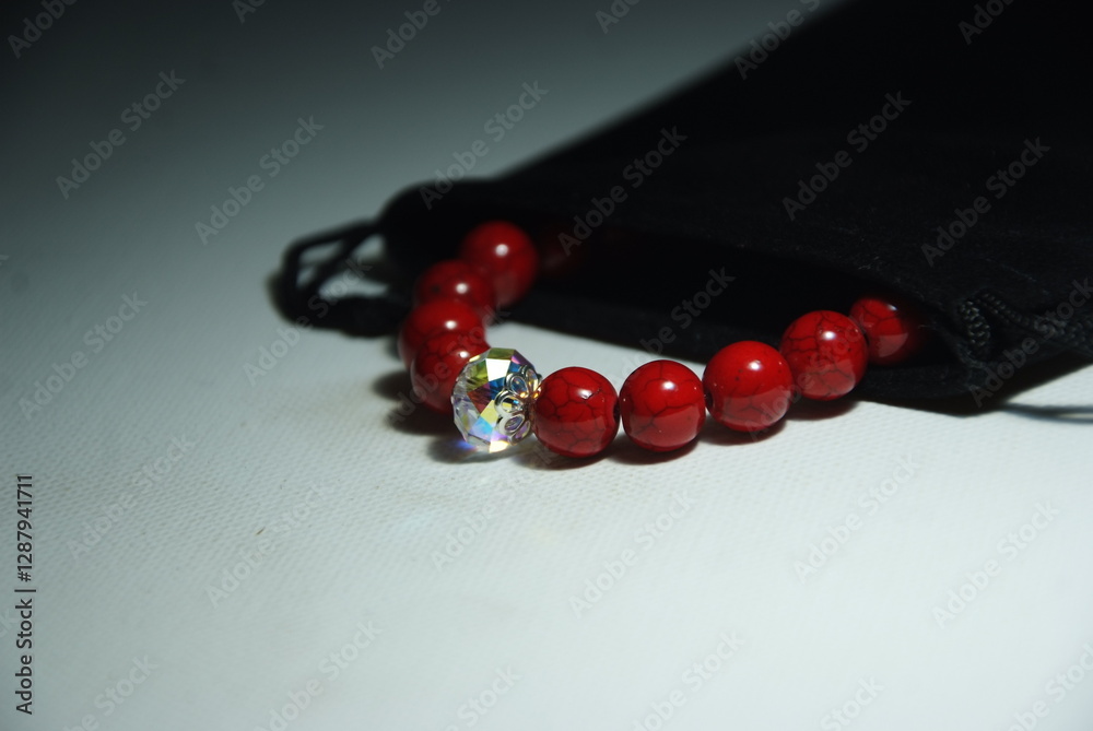 Bracelet in a black jewelry pouch. Exclusive red howlite bracelet with crystal