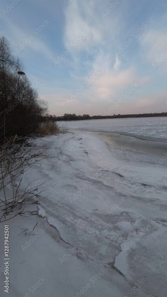 ice on the river. Ice floating slowly down the river in spring. River with floating frozen blocks of ice. Snowdrifts and trees in frost on the shore. ice on the river. vertical video 4k ice on the river. Ice floating slowly down the river in spring. River with floating frozen blocks of ice. Snowdrifts and trees in frost on the shore. ice on the river. vertical video 4k