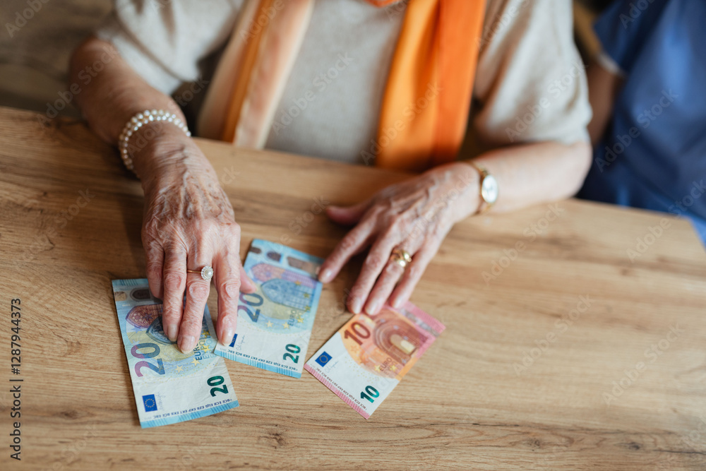 Obraz premium Close up of old woman laying banknotes on table.