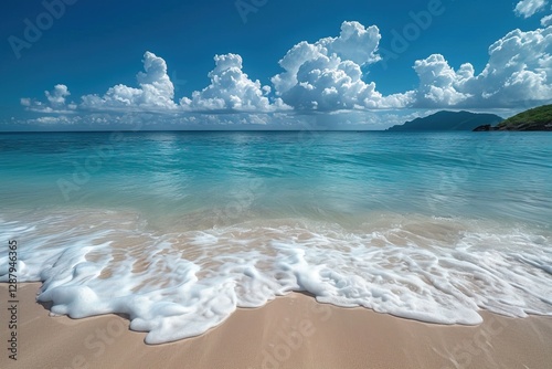 Fototapeta Naklejka Na Ścianę i Meble -  Big ocean wave on sandy beach with blue sky and white clouds