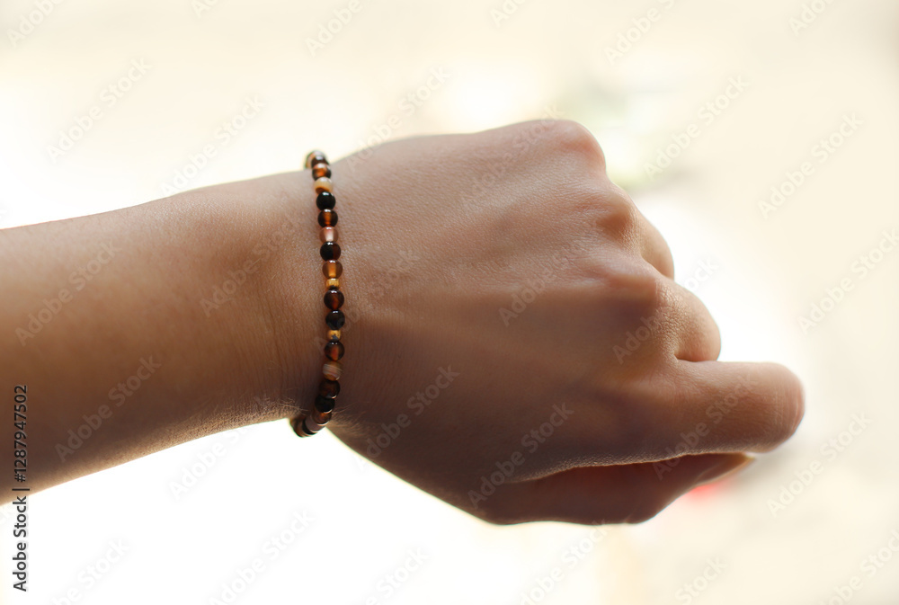 Bracelet Made of Natural Amber on a Woman's Hand