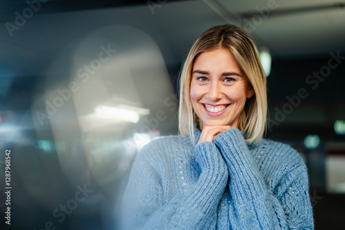 Portrait of a smiling woman in a blue sweater indoors photo