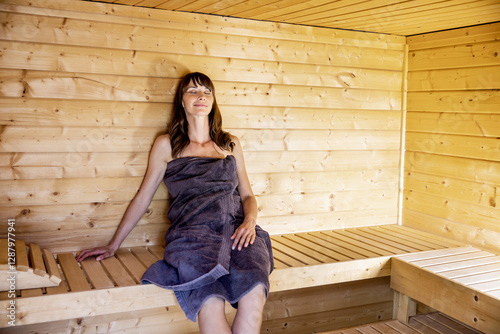 Woman relaxing in a sauna photo