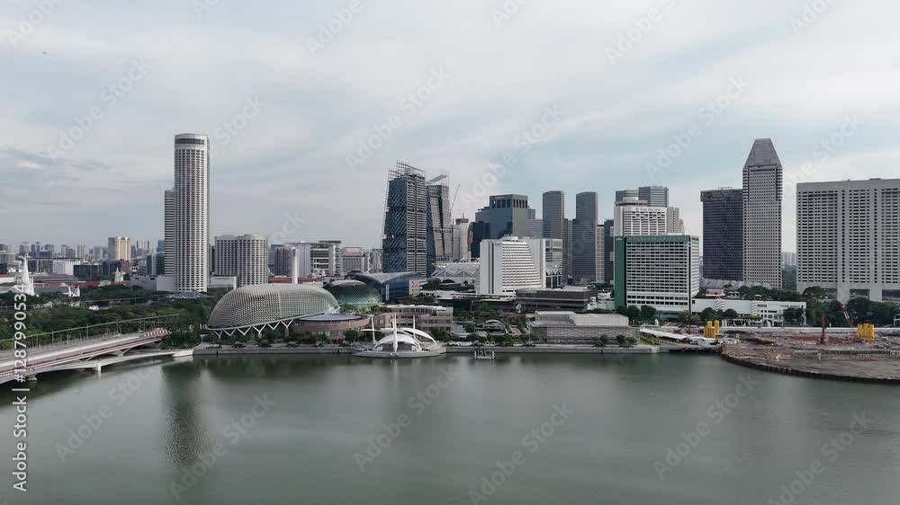 Flight along singapore skyline panorama with skyscrapers, hotels and construction site at Marina bay Flight along singapore skyline panorama with skyscrapers, hotels and construction site at Marina bay