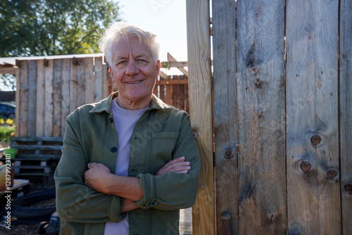 Person enjoying a sunny day outdoors near a wooden hut in a rural setting photo