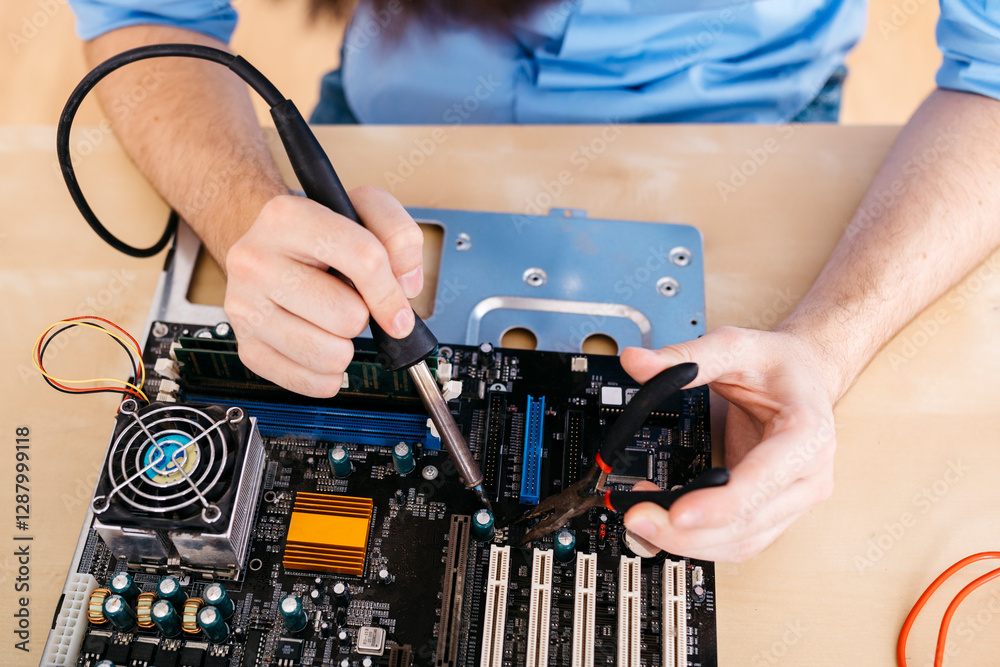 Close-up of technician repairing a desktop computer, soldering a component with tin Close-up of technician repairing a desktop computer, soldering a component with tin