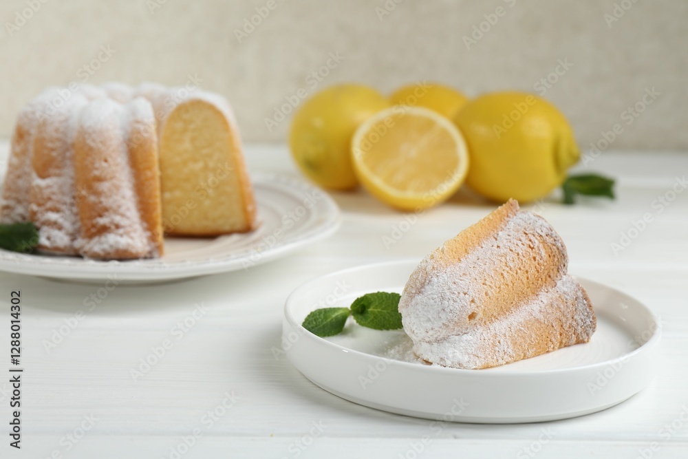 Piece of delicious lemon cake with powdered sugar and mint on white wooden table Piece of delicious lemon cake with powdered sugar and mint on white wooden table