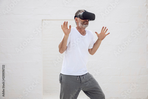 Mature man discovering empty space with VR goggles