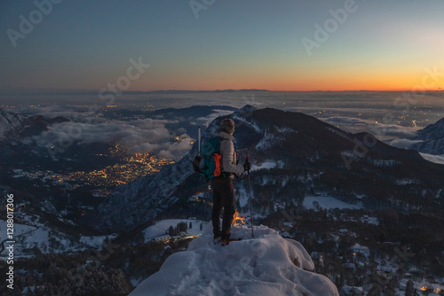 Mountaineer on the mountain summit during twilight, Orobie Alps, Lecco, Italy photo