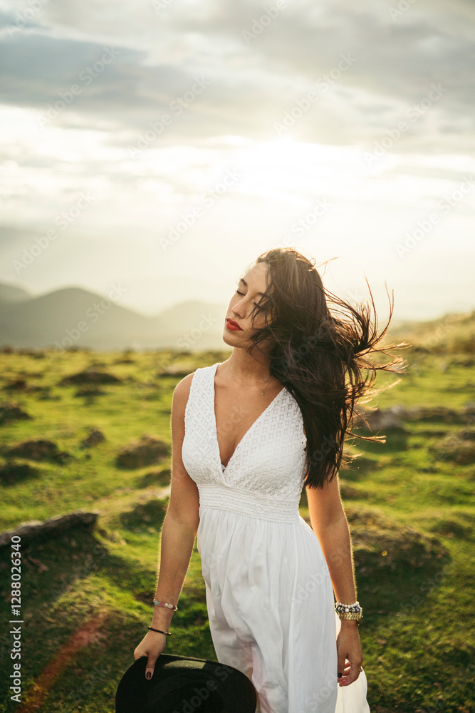 Young woman wearing white dress on viewpoint at sunset Young woman wearing white dress on viewpoint at sunset