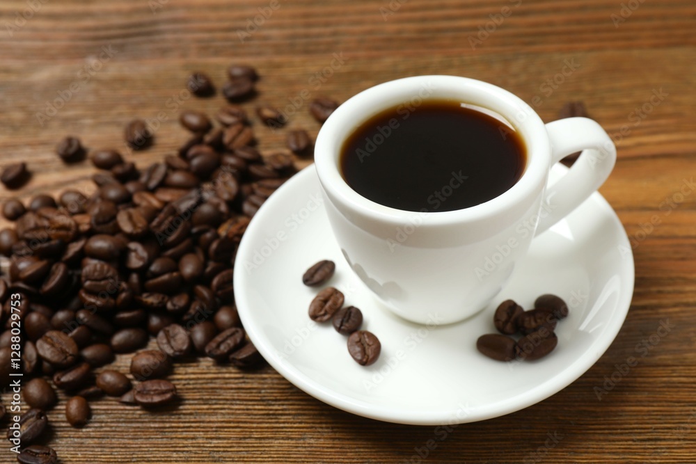 Cup of coffee with fresh coffee beans on wooden background Cup of coffee with fresh coffee beans on wooden background