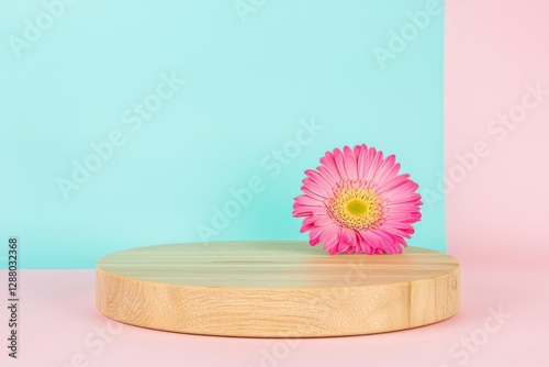 Cosmetic beauty products are presented on an empty mockup of a wooden round podium pedestal set against a pink background adorned with gerbera flowers