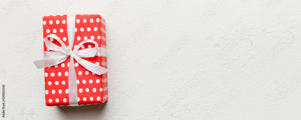 Valentine day composition: red gift box with bow and heart. Christmas present. View from above. Space for text. Holday greeting card Valentine day composition: red gift box with bow and heart. Christmas present. View from above. Space for text. Holday greeting card