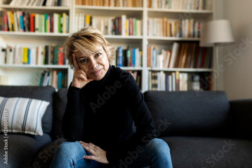Portrait of mature woman sitting on couch at home