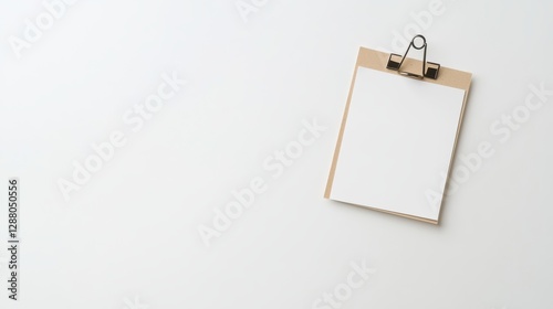 Minimal clipboard with blank paper on a white background for office or school stationery concept. photo